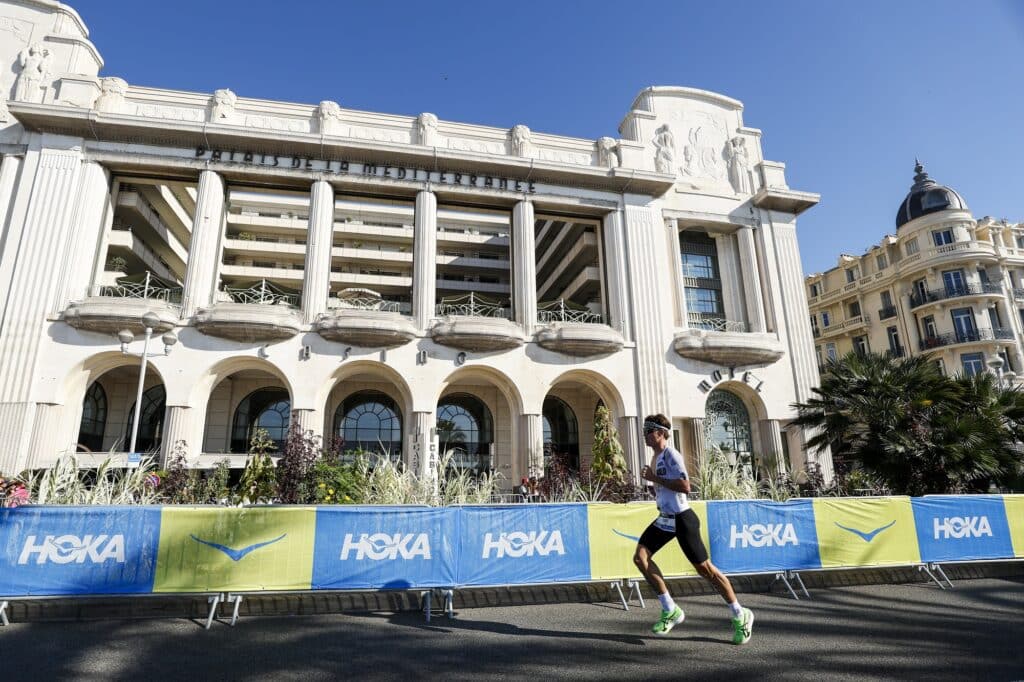 The Palace of the Mediterranean with athletes running in front.