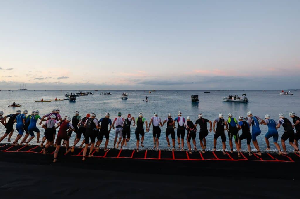The athletes ready to dive into the water at the start of the race.