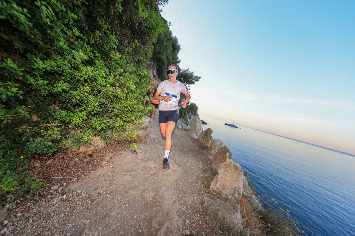 A runner is running along the sea.