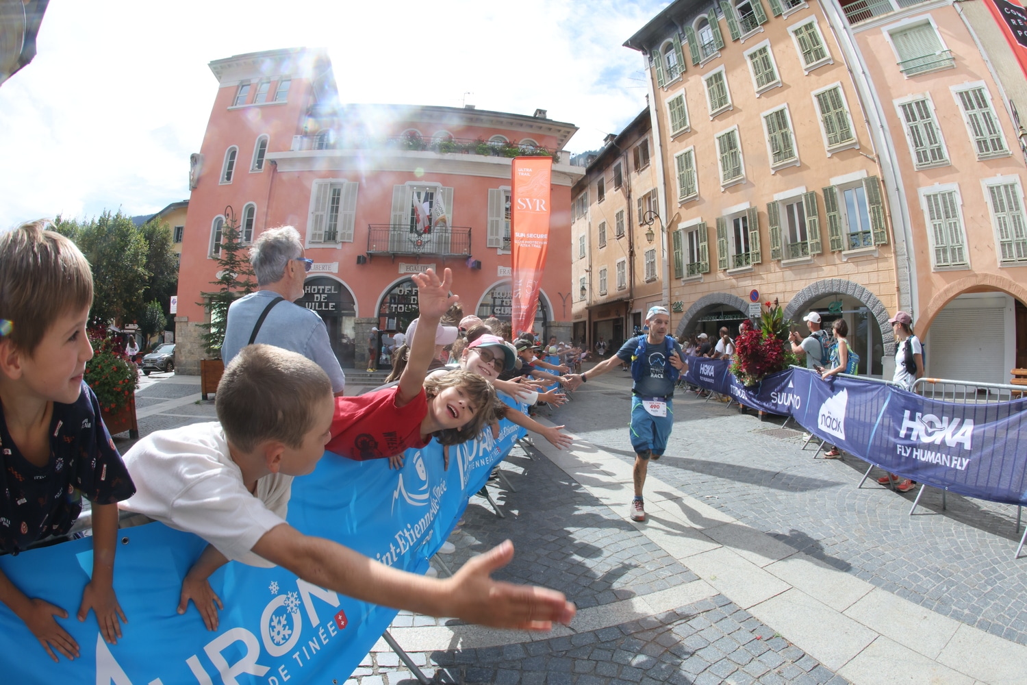 A runner high-fives spectators.