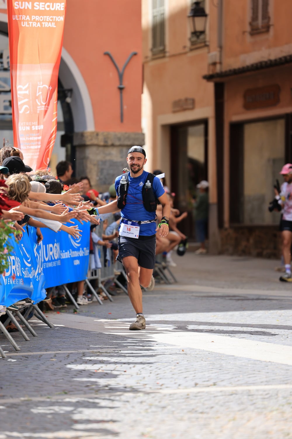 A runner high-fives spectators.