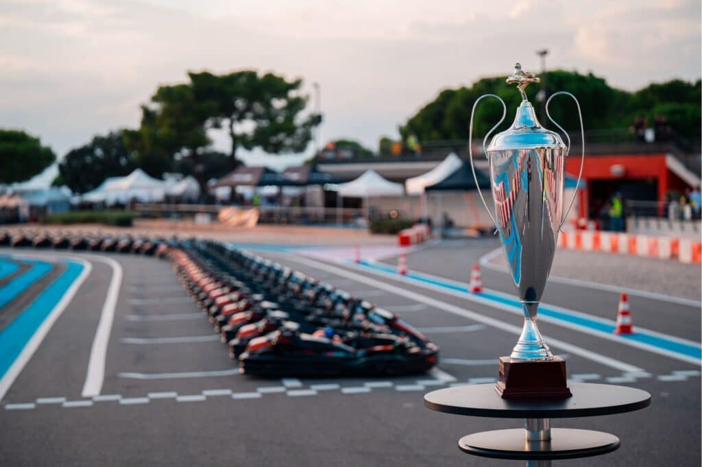 The karts lined up before the start of the event as well as the cup in the foreground