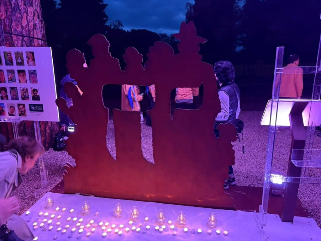 A scattering of candles in front of the October 7, 2023 memorial for the 3 years