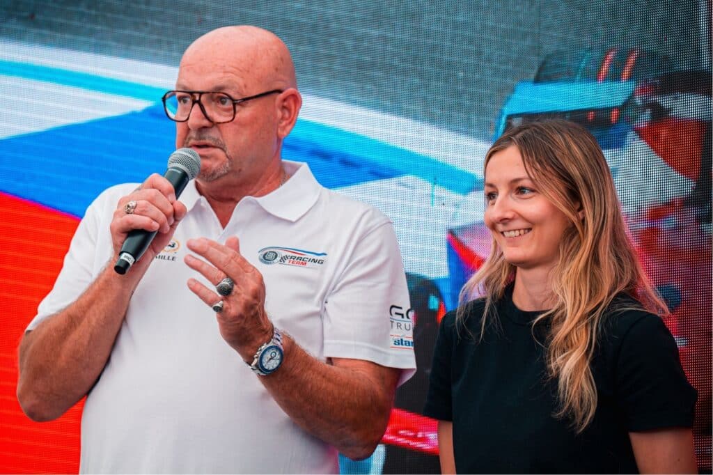 Philippe Bianchi and Doriane Pin with a microphone on the podium